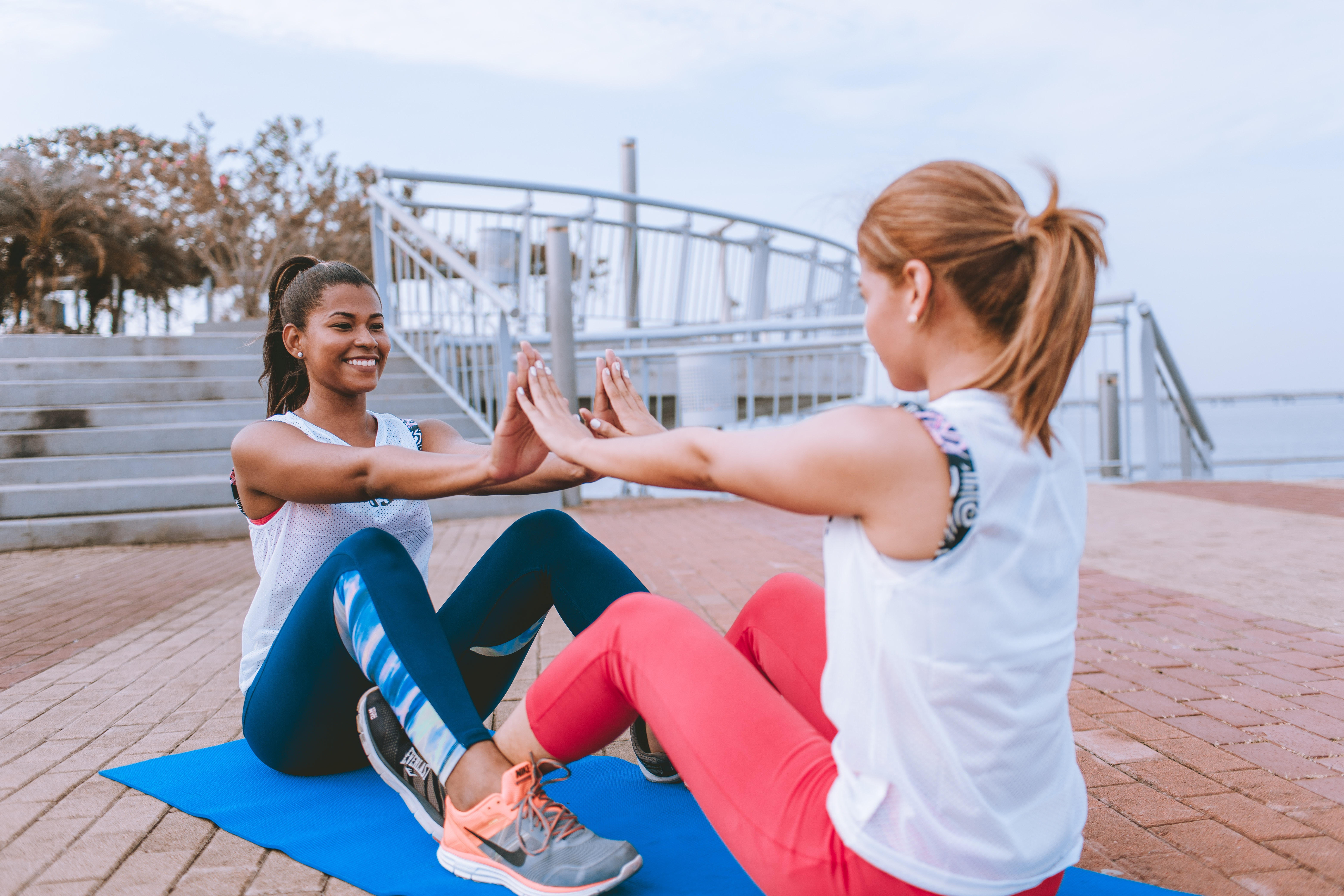 Friends doing outdoor ab workout