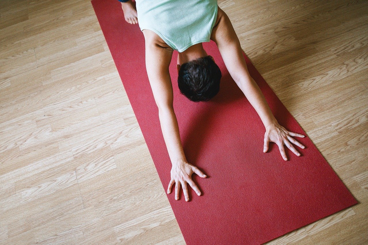 Downward Dog on a red mat